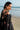 Black Musk black formal lehenga choli, over-the-shoulder close-up showing the sheer net back, tassel tie and beaded cold-shoulder sleeve