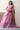 Crystal Blush blush pink bridal lehenga seated on steps with the four-sided embellished net dupatta