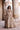 Full-length Dilnashin champagne gold lehenga choli with dupatta draped over the arm, Pakistani nikkah bridal wear