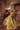 Resham yellow mehndi lehenga seated at a dressing table with the long train spread out