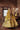 Resham yellow raw silk lehenga twirl with the dupatta as a veil in a brick-walled room