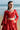 Waist-up view of the Ruby red choli with scalloped detailing, sequin work and crystal tassels