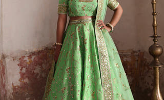 Zeba pistachio green Pakistani bridal lehenga choli in raw silk with thread and tilla embroidery, full front view