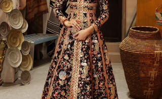 Open-front Pakistani pishwas worn over a lehenga: Fakhar un Nisa in black raw silk by Waqas Shah, comparing pishwas and lehenga silhouettes