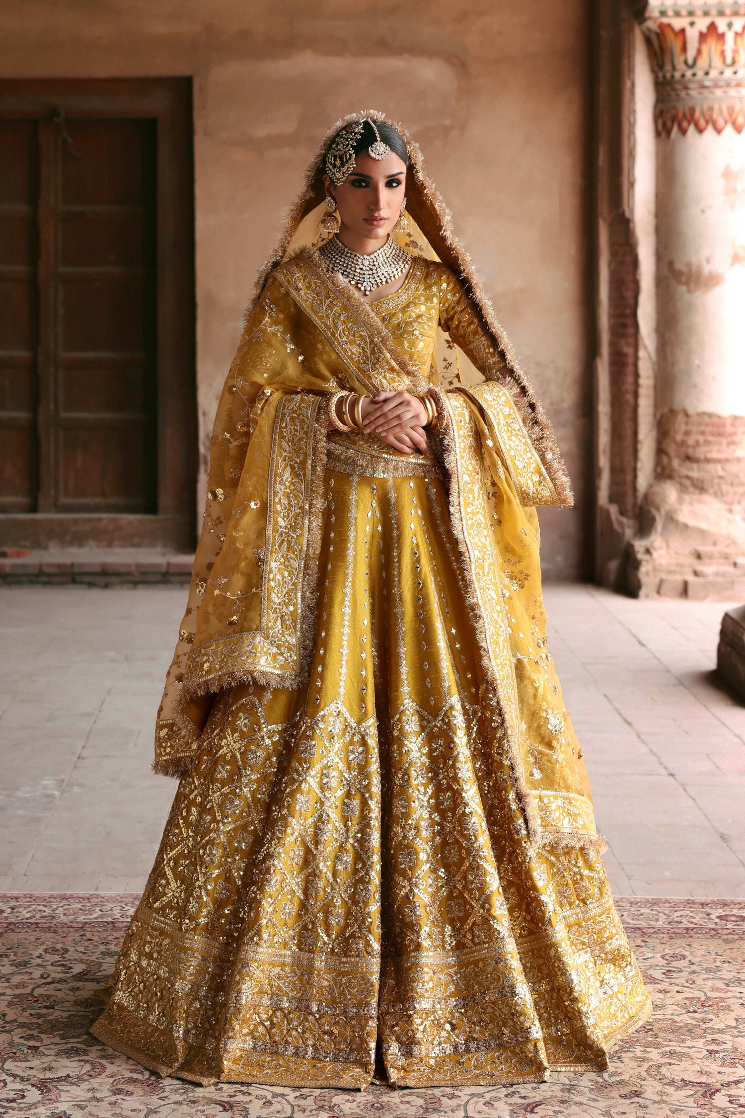 Resham yellow Pakistani mehndi lehenga choli from the Shakuntala collection by Waqas Shah