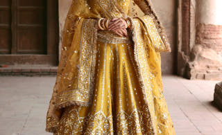 Resham yellow Pakistani mehndi lehenga choli from the Shakuntala collection by Waqas Shah