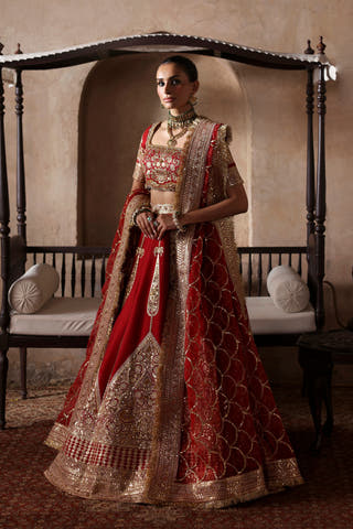 Simran red Pakistani bridal lehenga choli by Waqas Shah in raw silk, front view with the organza dupatta draped on one shoulder