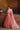 Avnoor salmon pink Pakistani lehenga choli back view showing the choli tassels and latkans