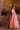Avnoor salmon pink Pakistani bridal lehenga side pose with organza dupatta trailing on the floor