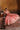 Avnoor salmon pink Pakistani lehenga choli seated with the mirror-worked skirt spread wide