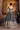 Back view of Geet navy lehenga choli before a warm-lit haveli arch