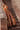 Gurleen rust brown lehenga on old haveli stairs, flared skirt and orange organza dupatta