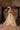 Saanvi skin gold lehenga choli standing under the painted dome of a Lahore haveli