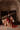 Seated view of the Simran red wedding lehenga in a haveli with the dupatta trailing