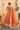 Back view of the Aabroo rust orange lehenga choli showing the tassel detailing on the choli