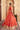 Back view of the Aarohi orange lehenga choli showing the flared embroidered lehenga