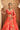 Side view of the Aarohi orange raw silk lehenga choli with floral tilla embroidery