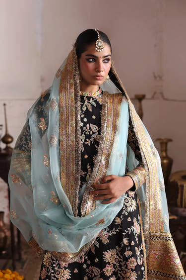 Close-up of the beautifully hand embellished round neckline with delicate mirror work showcasing exceptional Pakistani artisan craftsmanship.
