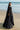 Full-length side view of the Black Musk black formal lehenga choli with the net dupatta falling from the shoulder, Pakistani formal wear