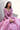 Crystal Blush blush pink formal lehenga choli seated, styled with an embellished potli
