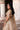 Dilnashin champagne gold lehenga choli from the side, showing the open-back blouse with beaded tassel hem