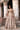 Full-length Dilnashin champagne gold Pakistani bridal lehenga choli with dupatta draped over the shoulder