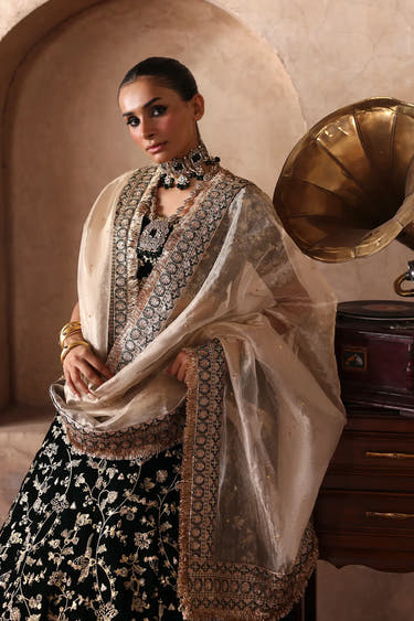 Luxury Dark Green Pakistani bridal lehenga featuring premium velvet, traditional Tilla work, mirror detailing and a delicate Tissue dupatta.