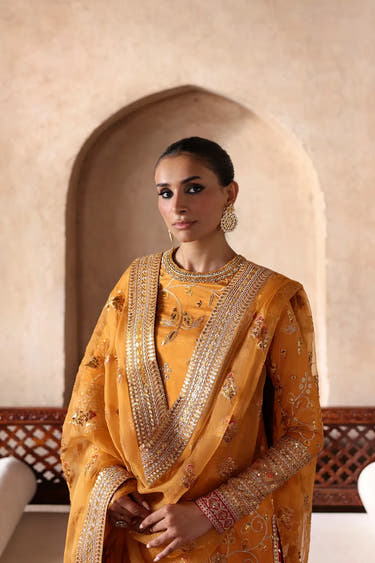 Luxury mustard gold Pakistani formal dress with a hand-embellished round neckline, embroidered straight-cut shirt and premium artisan craftsmanship by Waqas Shah Official.