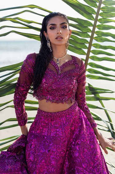 Waist-up view of the Lyric magenta choli showing sequin, bead and crystal hand embroidery on sheer net sleeves