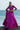 Lyric magenta Pakistani mehndi lehenga choli with hands on the waist and dupatta falling from the shoulder