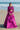 Lyric magenta pink formal lehenga choli worn with a matching embellished potli, Pakistani mehndi and wedding guest outfit