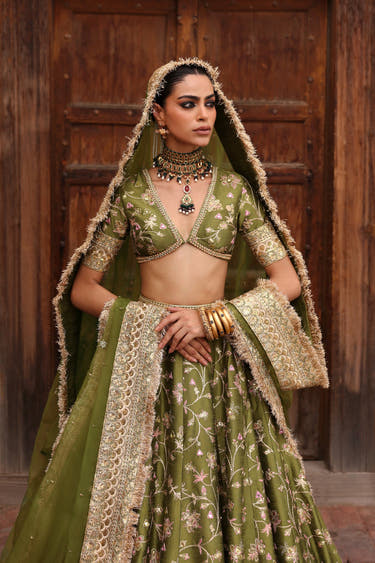 Mahira olive green mehndi bridal lehenga with the organza dupatta over the head