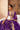 Mahrang purple mehndi lehenga choli seated, with the organza dupatta over the shoulder