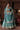 Manzil luxury teal and turquoise Pakistani bridal lehenga by Waqas Shah Official featuring a richly embroidered velvet ensemble with intricate jaal work.
