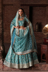 Manzil luxury teal and turquoise Pakistani bridal lehenga by Waqas Shah Official featuring a richly embroidered velvet ensemble with intricate jaal work.
