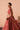 Side view of the Mastani red mehndi lehenga showing the golden tilla embroidery on raw silk