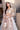 Mystic Rose white formal lehenga choli styled with a hand-embellished potli, Pakistani designer wear