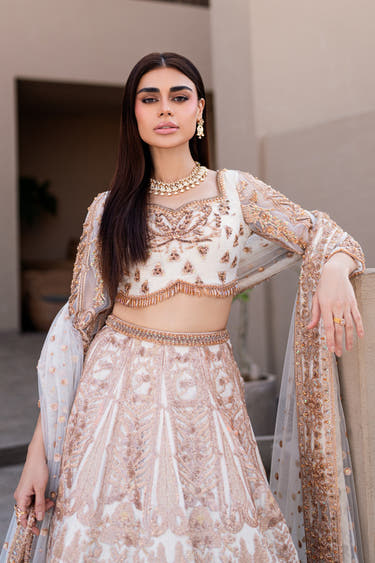 Full-length Mystic Rose white nikkah lehenga choli worn with the sheer embellished net dupatta