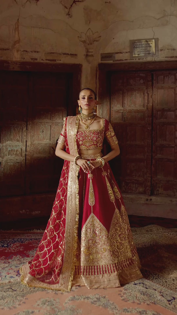 Video of the Simran red bridal lehenga choli in raw silk, showing the flare, hand-worked choli and organza dupatta