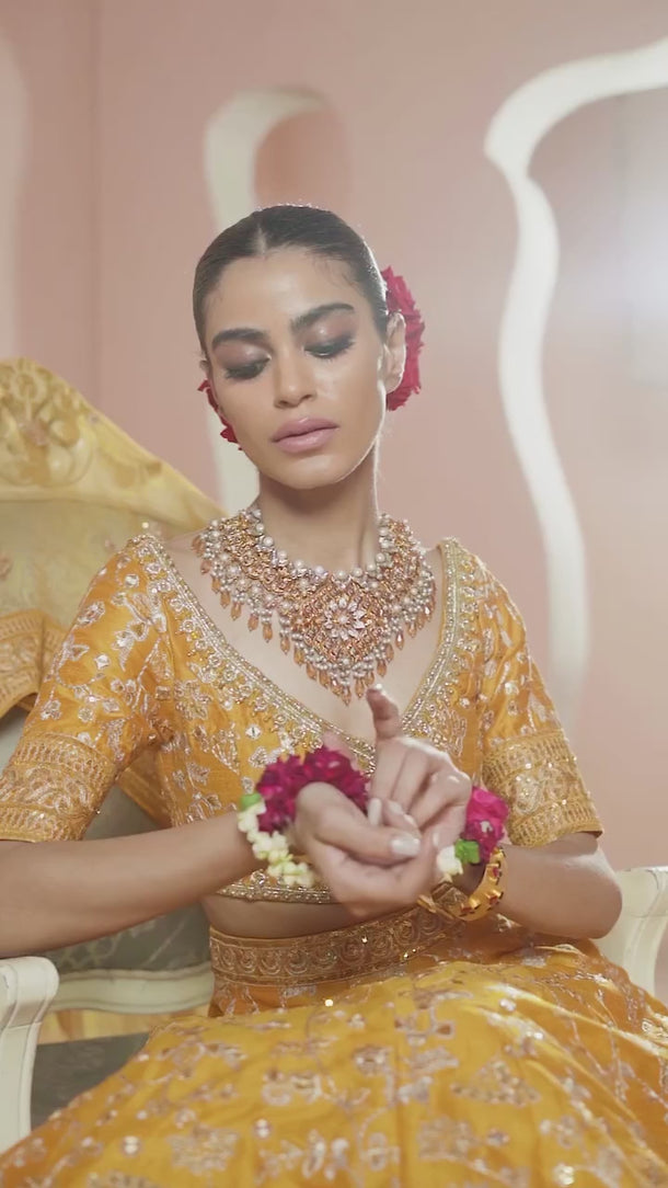 Video of Zari mustard yellow Pakistani mehndi lehenga choli in motion, showing the golden tilla embroidery, mirror work and flare – Waqas Shah