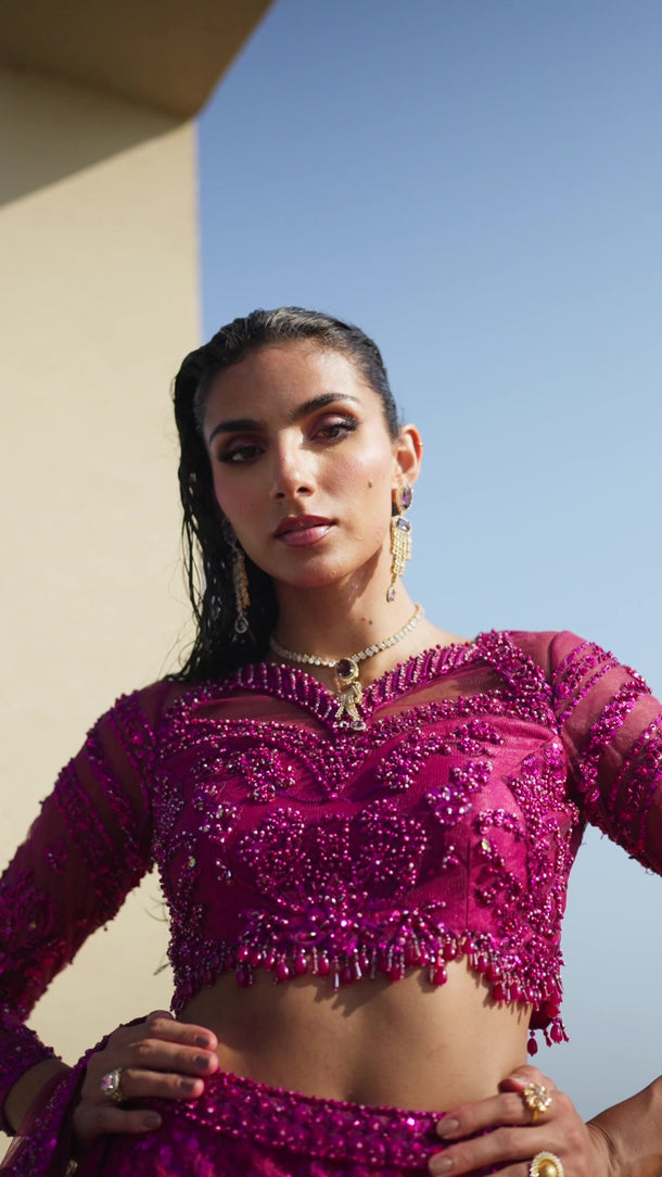 Video of Lyric magenta Pakistani bridal lehenga choli in motion, showing the sequin lehenga, net sleeves and flowing net dupatta – Waqas Shah