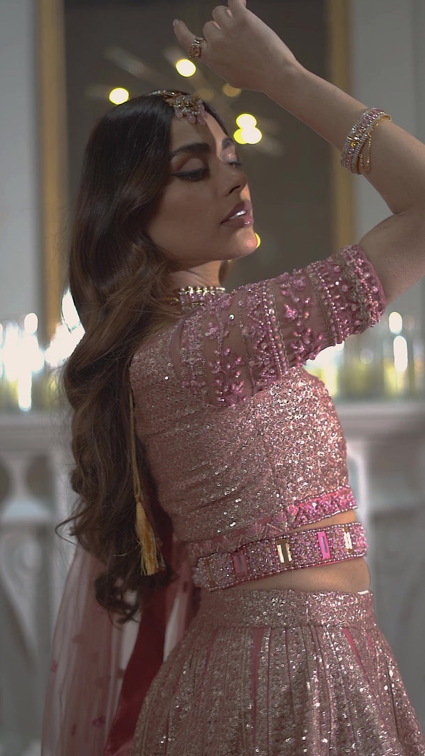 Primrose tea pink lehenga choli in motion, showing the rose-gold sequins, hand-embellished choli and net dupatta