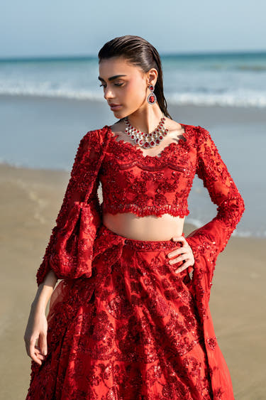 Ruby red bridal lehenga choli worn with the heavily embellished dupatta, Pakistani barat look