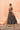 Back view of the Shah Bano dark green lehenga choli showing the flared mirror work lehenga