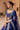 Side view of the Shahnaaz midnight blue bridal lehenga choli with the organza dupatta over the arm
