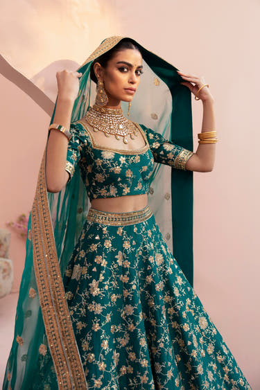 Shahrbanu emerald green mehndi bridal lehenga with the organza dupatta over the head