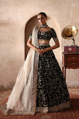 Taseer luxury Dark Green Pakistani bridal lehenga by Waqas Shah Official featuring a rich velvet lehenga and choli with intricate floral and botanical embroidery.