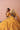 Zari mustard yellow mayon and mehndi lehenga choli, seated portrait with floral hair styling
