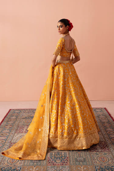 Back view of the Zari mustard yellow mehndi bridal lehenga with the pure organza dupatta and embroidered border