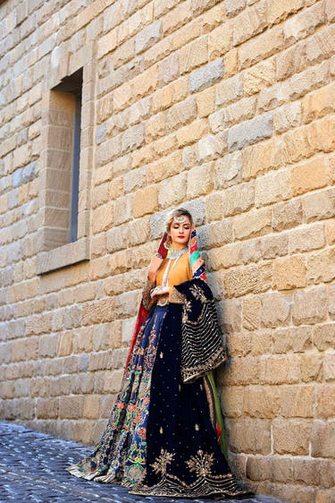 Mustard Gold and Blue Pakistani Mehndi Lehenga with traditional bridal embroidery by Waqas Shah Official